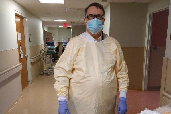 Paul Lehmann, in mask and gloves, stands in hospital.